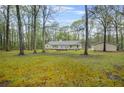 Spacious backyard with mature trees and a detached garage at 125 Bridget Dr, Hampton, GA 30228