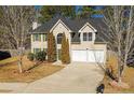 Charming two-story home with a well-maintained lawn, a two-car garage, and mature trees at 2695 Virginia Cv, South Fulton, GA 30296