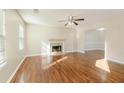 Inviting living room with a fireplace, ceiling fan, wood-look flooring, and natural light at 2695 Virginia Cv, South Fulton, GA 30296