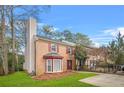 Brick townhouse featuring a bay window and manicured lawn with mature trees at 1751 Twin Brooks Se Dr, Marietta, GA 30067