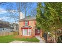 Traditional townhouse with brick facade, red accents and a neat front yard at 1751 Twin Brooks Se Dr, Marietta, GA 30067