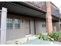 Condo exterior with covered entry, brick details, and iron balcony above front door at 3083 Colonial Way # N, Atlanta, GA 30341