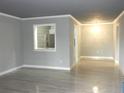 Open living room featuring sleek gray walls, modern flooring, and a pass-through window to the kitchen at 3083 Colonial Way # N, Atlanta, GA 30341