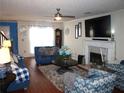 Cozy living room with hardwood floors, fireplace, and a large window at 3738 Windy Hill Se Dr, Conyers, GA 30013