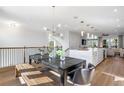 Open-concept dining room with modern chandelier adjacent to the kitchen and living room at 1119 Rivard Nw Cir, Atlanta, GA 30318