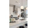 Close up of modern white kitchen with stainless steel appliances and a large island at 22 Airline Ne St # 403, Atlanta, GA 30312