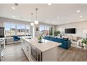 Modern living room and kitchen featuring stainless steel appliances, a large island, and a comfortable seating area at 22 Airline Street Ne # 403, Atlanta, GA 30312