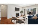 Living room features a fireplace, TV, blue sofa, desk in background, and balcony access at 23310 Plantation Dr, Atlanta, GA 30324