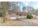 Cozy brick home with an attached garage and front porch, offering a warm and inviting curb appeal at 301 Lady Agatha Ct, Jonesboro, GA 30236