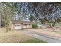 Quaint brick home featuring an attached garage and front porch, complemented by a well-maintained driveway at 301 Lady Agatha Ct, Jonesboro, GA 30236