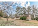 Charming brick home with attached garage and inviting front porch, surrounded by mature trees and a lush lawn at 301 Lady Agatha Ct, Jonesboro, GA 30236