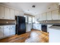 Functional kitchen with white cabinets and essential appliances set on hardwood flooring at 3483 Napoleon St, Atlanta, GA 30337