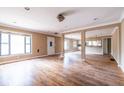 Open living area with hardwood floors, large windows, and open layout kitchen at 3483 Napoleon St, Atlanta, GA 30337