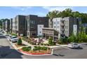 Modern apartment complex with outdoor seating area, landscaping, and parking at 383 Grant Se Cir # 1634, Atlanta, GA 30315