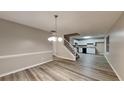 Bright living room with wood flooring, staircase, and open access to a modern kitchen at 640 City Park Dr, Mcdonough, GA 30252