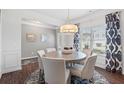 Cozy dining room featuring a round table, chairs, a patterned rug, and large windows for ample natural light at 154 Calla Dr, Douglasville, GA 30134