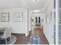 Inviting entryway featuring wood floors, neutral walls, and a view into the adjacent dining room at 154 Calla Dr, Douglasville, GA 30134