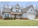 Attractive two-story home with an attached garage, lush lawn, and traditional craftsman appeal at 260 Harmony Woods Dr, Dallas, GA 30157