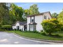 Charming two-story home with a landscaped yard, white brick, black shutters and a manicured lawn at 2861 Dorby Close Ne, Brookhaven, GA 30319