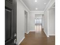 Inviting foyer with hardwood floors and a view of the living area's natural light at 404 Village Ln, Fairburn, GA 30213