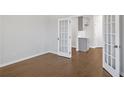 Versatile room featuring hardwood floors and glass French doors at 404 Village Ln, Fairburn, GA 30213