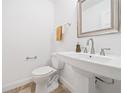 Traditional powder room featuring a pedestal sink, brushed nickel faucet, and a square framed mirror at 1659 Executive Park Ne Ln, Brookhaven, GA 30329