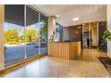 Lobby of building featuring front desk with wood paneling, views of the exterior and dark marble accent wall at 215 Piedmont Ne Ave # 204, Atlanta, GA 30308