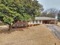 Traditional brick home with covered entrance, mature tree, and front yard at 2798 Tralyn Ct, Decatur, GA 30034