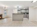 Bright living room and kitchen featuring a breakfast bar and tile floors at 434 Mcgill Ne Pl, Atlanta, GA 30312