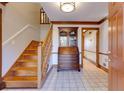 Welcoming foyer with wood staircase, tiled floor, and wood trim at 1645 Dunwoody Sq, Dunwoody, GA 30338