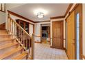 Foyer featuring wood staircase, tile flooring, and access to the living room at 1645 Dunwoody Sq, Dunwoody, GA 30338