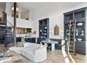 Open-concept living room featuring spiral staircase, kitchen with bar seating, and custom-built shelving at 170 Boulevard Se # 412E, Atlanta, GA 30312