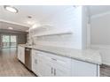 Well-lit kitchen with stainless steel appliances, granite countertops, subway tile backsplash, and open shelves at 20 Ivy Ne Rdg, Atlanta, GA 30342