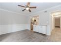 Bright living room with modern flooring, wainscoting, and ceiling fan at 20 Ivy Ne Rdg, Atlanta, GA 30342