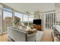 Bright living room with floor-to-ceiling windows offering panoramic city views and modern furniture at 3325 Piedmont Ne Rd # 1907, Atlanta, GA 30305