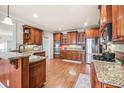 Traditional-style kitchen featuring custom cabinets, granite countertops, and stainless steel appliances at 1526 Rocky River Dr, Lawrenceville, GA 30045