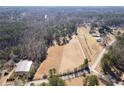 Expansive aerial view of land featuring fields, homes, outbuildings, and natural growth at 202 Neely Rd, Fayetteville, GA 30214