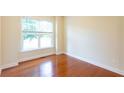 Neutral bedroom with hardwood floors, large window, and ample natural light at 3455 Dalwood Dr, Suwanee, GA 30024