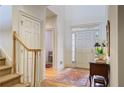 Spacious foyer featuring hardwood floors and a staircase with wooden banister at 3923 Ashford Ne Trl, Brookhaven, GA 30319