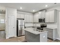 Modern kitchen with stainless steel appliances, granite countertops and grey cabinets at 5063 Lower Elm St, Atlanta, GA 30349