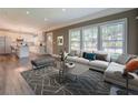 Staged living room featuring a large sofa, rug, and a view into the kitchen at 577 Center Hill Nw Ave, Atlanta, GA 30318