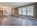 Bright, open-concept living room featuring hardwood floors, large windows, and a view into the kitchen at 577 Center Hill Nw Ave, Atlanta, GA 30318