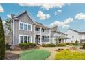 Beautiful two-story home with a welcoming double-decker porch and lovely landscaping at 2304 Isla Run, Woodstock, GA 30188
