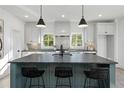 Bright kitchen featuring a center island, modern appliances, and stylish pendant lighting at 3326 Springhaven Ave, Hapeville, GA 30354