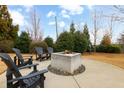 Community fire pit with Adirondack chairs on a concrete patio with lush landscaping at 4374 Benfield Se Way, Smyrna, GA 30080