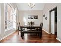 Elegant dining room featuring wood floors, a large window, and stylish furnishings at 565 Saint James Ct, Lawrenceville, GA 30044