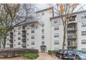 View of the apartment complex with multiple floors, balconies, beautiful trees, and landscaped areas at 970 Sidney Marcus Blvd # 1217, Atlanta, GA 30324