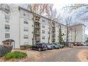 Exterior view of the apartment complex, featuring a parking area, manicured landscaping and multiple balconies at 970 Sidney Marcus Blvd # 1217, Atlanta, GA 30324