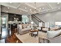 Spacious living room with hardwood floors, decorative coffered ceilings, and modern furnishings at 1180 John Collier Rd, Atlanta, GA 30318