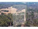 Aerial shot showing approximately 37.48 acres of land with a mix of cleared areas and wooded sections at 1570 Butler Bridge Rd, Covington, GA 30016